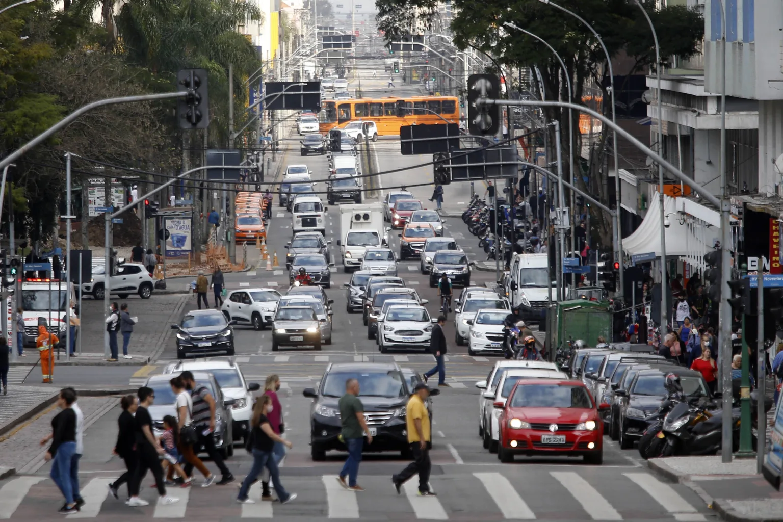 a busy city street with cars and people walking