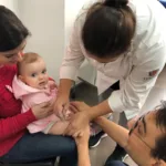 a woman holding a baby