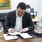 Governador Carlos Massa Ratinho Junior assinando documento do governo do Estado do Paraná